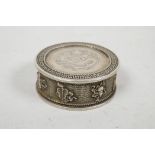 A Chinese white metal coin box and cover, the sides decorated with the emblems of the Eight Immortal