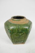 An C18th South China pottery storage jar, the surface with raised floral motifs below a mottled gree