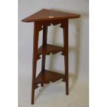 An Arts & Crafts oak three tier corner open stand, 16" x 37"