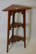 An Arts & Crafts oak three tier corner open stand, 16" x 37"