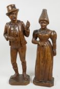 A pair of Bavarian Black Forest carved wood figures of a lady and Gentleman dressed in traditional c