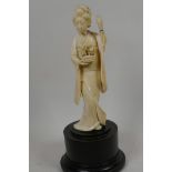 A 1920s Japanese carved ivory figure of a geisha with a basket of flowers, 7" high, A/F