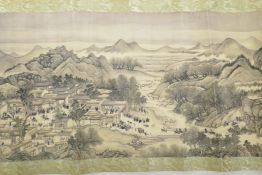 A Chinese printed scroll decorated with figures in an extensive landscape, 10½" high