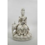 A Chinese blanc de chine Quan Yin seated on an elephant, impressed marks verso, 13" high