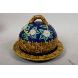 A majolica covered dish decorated with a woven fence and dog roses, 7¾" diameter