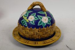 A majolica covered dish decorated with a woven fence and dog roses, 7¾" diameter