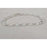 A silver, cubic zirconium and opalite tennis style bracelet