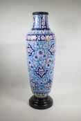 A Persian Iznik pottery vase decorated with a floral pattern, A/F, repairs, 29" high