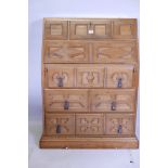 A Spanish hardwood fall front bureau fitted with two drawers and pigeon holes, over three long drawe