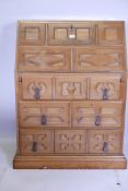 A Spanish hardwood fall front bureau fitted with two drawers and pigeon holes, over three long drawe