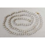 A freshwater pearl necklace with gold clasp, 34" long