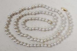 A freshwater pearl necklace with gold clasp, 34" long