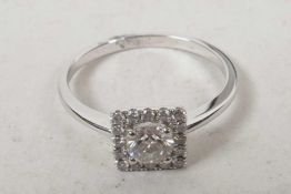 An 18ct white gold square cut diamond cluster ring (60 points), size M/N