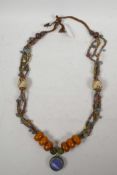 A Sino-Tibetan necklace with white metal, glass shell and composition beads, 36" long