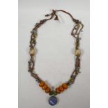 A Sino-Tibetan necklace with white metal, glass shell and composition beads, 36" long