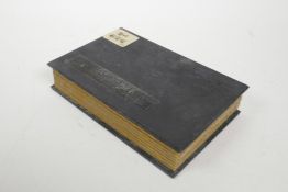 A Chinese silk and wood bound book containing green jade tablet and pages with engraved and gilt cha