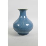A Chinese blue glazed porcelain vase with a flared gilt rim and underglaze floral decoration, seal m