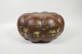 A Chinese red lacquer gourd shaped box with figural and gilt scrolling decoration, 11" diameter