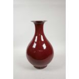 A Chinese sang de boeuf glazed porcelain pear shaped vase, 4 character mark to base, 12½" high