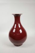 A Chinese sang de boeuf glazed porcelain pear shaped vase, 4 character mark to base, 12½" high