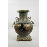 A Chinese mottled green and black pottery vase with ormolu style handles and base, the sides decorat