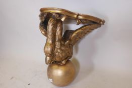 A C19th carved giltwood wall bracket in the form of a swan, the top pointed as marble, 18" high x 19