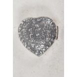 A small sterling silver heart shaped pill box with embossed figural decoration