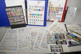 A collection of all world postage stamps, in two albums, collection strips and loose