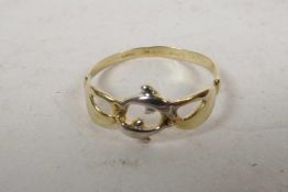 A 9ct yellow gold Claddagh style ring made as hands holding two dolphins, size 'S'