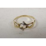 A 9ct yellow gold Claddagh style ring made as hands holding two dolphins, size 'S'