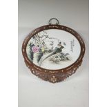 An oval Chinese famille verte porcelain panel decorated with Asiatic birds and flowers, mounted in a