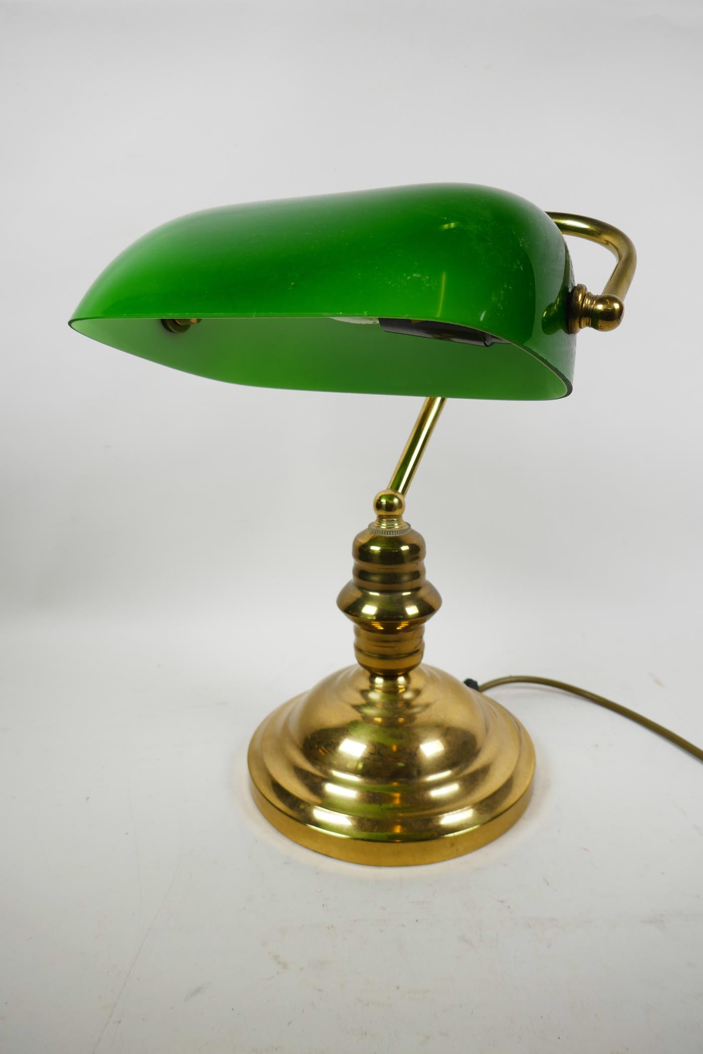A brass desk lamp with adjustable green glass shade, 13" high
