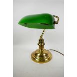 A brass desk lamp with adjustable green glass shade, 13" high