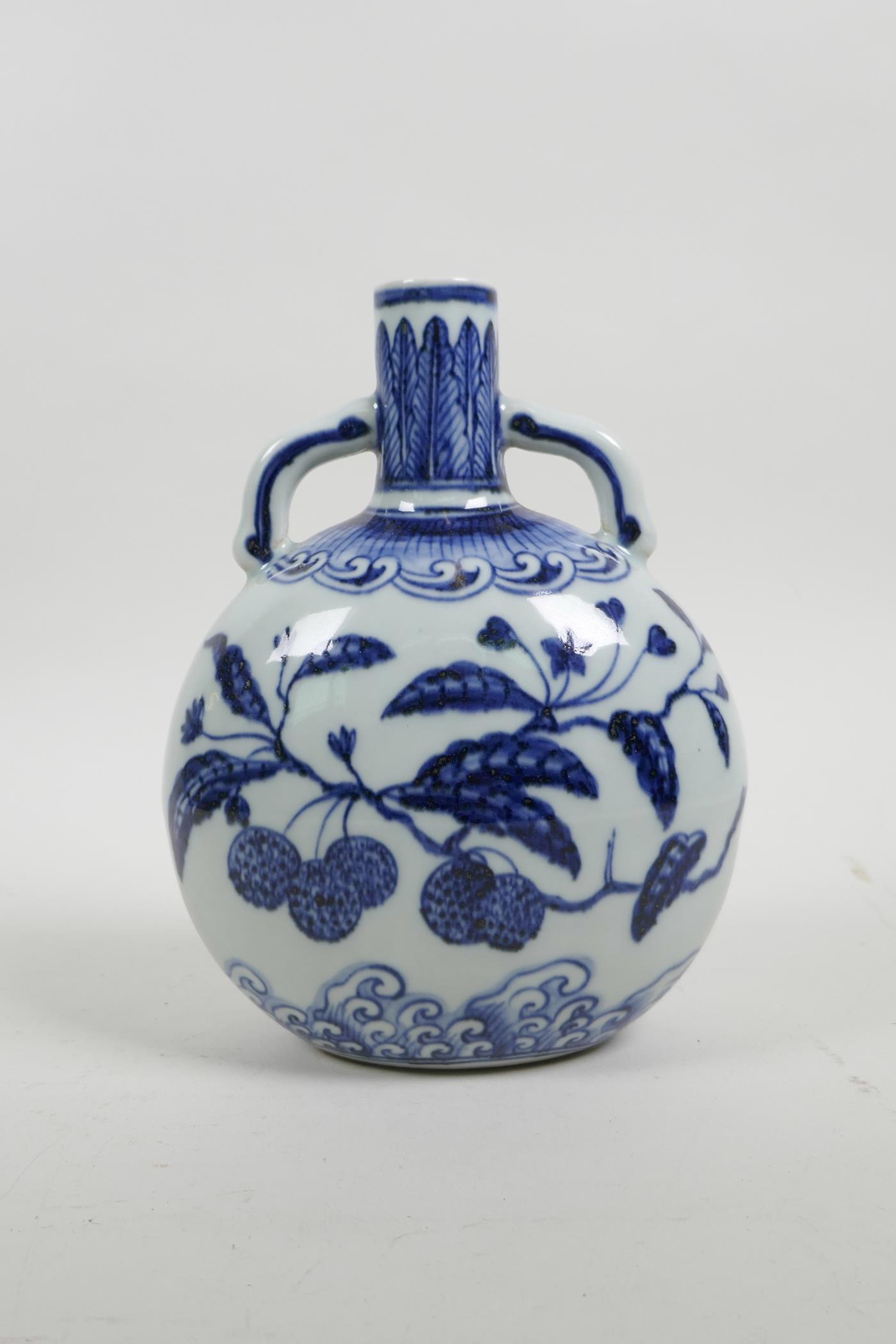 A Chinese blue and white porcelain two handled moon flask decorated with branches bearing fruit, 4 c