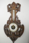 A Soviet banjo barometer/thermometer in a carved wood case, 18" long