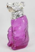 An amethyst glass decanter in the form of a seated bear with silver plated collar and head, 9" high