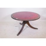 A mahogany occasional table with leather inset top, raised on a turned column with reeded splay supp