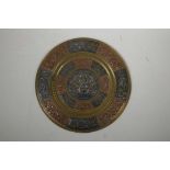 An Indian brass wall plaque with inlaid repousse copper and metal decoration of Ganesh and exotic bi