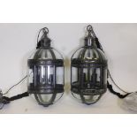 A pair of contemporary bronzed metal pendant lanterns, 27" long