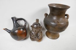 A small ethnographic pottery jug formed as a kneeling man playing pipes, 6" high, a red earthenware