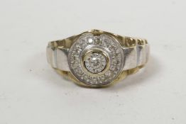 A men's 9ct gold decorative ring inset with a round brilliant cut diamond and surrounded by pave dia
