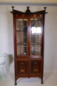 An Art Nouveau style mahogany inlaid corner cabinet, inlaid with copper and pewter, in the manner of