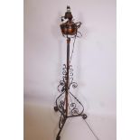 A wrought iron and copper standard oil lamp converted to electricity, 56" high