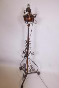 A wrought iron and copper standard oil lamp converted to electricity, 56" high