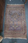 A Persian brown ground wool rug with geometric blue and red decoration, 47" x 75"