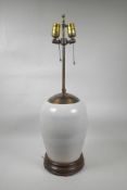 An Oriental crackleware lamp with brass fittings on a hardwood base, 27" high