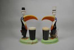 Two Carltonware porcelain Guinness toucan table lamps, 12" high, both A/F