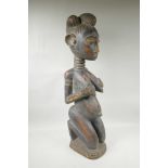 An African carved hardwood maternity figure, 30" high