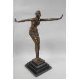 An Art Deco style bronze figure of a dancing girl on a stepped marble base, 16½" high