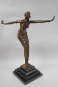 An Art Deco style bronze figure of a dancing girl on a stepped marble base, 16½" high